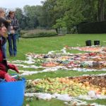 Kate Raggett invites the public to add their color to the land art